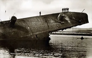 Men stand on forepart of part-submerged German Battlecruiser Men stand on forepart of part-submerged German Battlecruiser