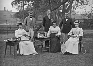 Men and women taking tea in a garden Men and women taking tea in a garden