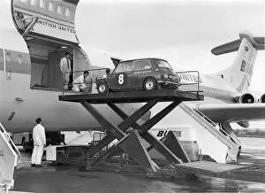 A mini car being loaded through the side cargo door