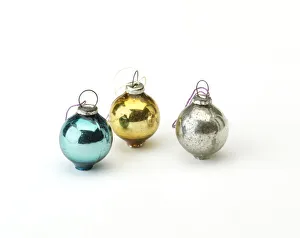 <b class=qtipBold><figcaption>Miniature Christmas baubles</figcaption></b><br>Set of 12 miniature coloured Christmas tree baubles in their original packaging, a printed red, cream and green cardboard box with a cellophane window, manufactured c.1950-1960. Date: c.1950-1960<br><em>© The Geffrye Museum of the Home / Mary Evans Picture Library</em> Miniature Christmas baubles