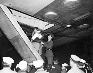 Return Gallery: Miss Mary Day Winn of New York is helped aboard LZ 129 H?