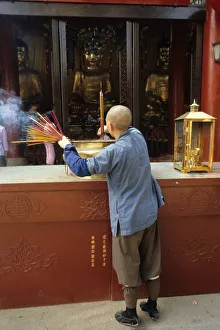 Monk and incense, Temple of the Six Banyan Trees Monk and incense, Temple of the Six Banyan Trees
