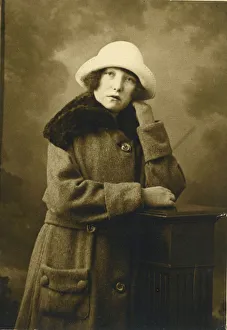 A rather morose looking young woman poses for a studio photograph. Date: c.1923 A rather morose looking young woman poses for a studio photograph. Date: c.1923