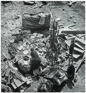 Mother searching for her belongings in debris 1939 Mother searching for her belongings in debris 1939