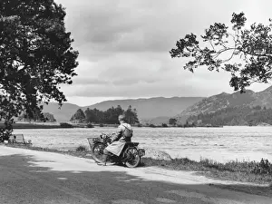 Prints of A motorcyclist pauses to admire the view at Ullswater, the English Lucerne one of the most beautiful of the lakes in the Lake District Lake Prints: Motorcyclist at Ullswater Lake District Print