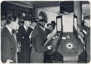 London Underground History Prints: Photograph showing a queue of passengers waiting to use the new mechanical informator at Charing Cross Underground