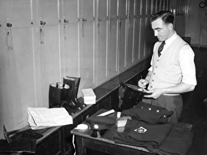 <b class=qtipBold><figcaption>New LFB recruit marking his gear</figcaption></b><br>A new LFB recruit marking his gear -- locker space is provided.<br><em>© London Fire Brigade / Mary Evans Picture Library</em> New LFB recruit marking his gear