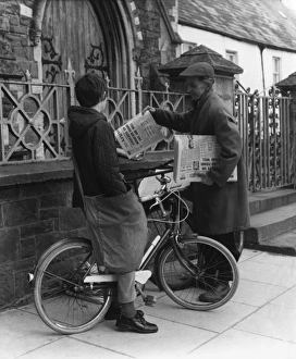 <b class=qtipBold><figcaption>News Round Boy 1950S</figcaption></b><br>Delivering newspapers on his bicycle, a boy pauses to speak to a colleague. Date: 1950s<br><em>© Mary Evans Picture Library/HENRY GRANT</em> News Round Boy 1950S