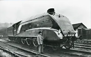Nigel Gresley standing alongside his A4 class steam engine Nigel Gresley standing alongside his A4 class steam engine
