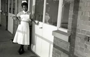 New Images May Gallery: Nottingham. Student, Esmel May Woma in her nurses uniform leaning against the hospital