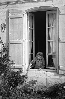 1991 Gallery: Old lady leans out of her house window - St Martin, France