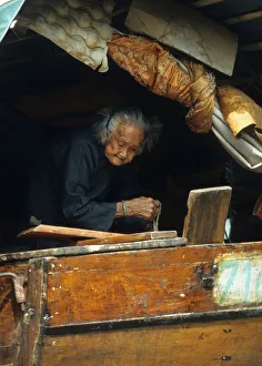 An old woman on a junk in a typhoon shelter, Hong Kong An old woman on a junk in a typhoon shelter, Hong Kong