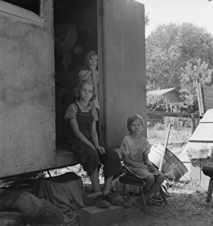 The oldest girl seated in the doorway of the house trailer c The oldest girl seated in the doorway of the house trailer c