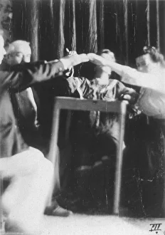 <b class=qtipBold><figcaption>Palladino at Genova</figcaption></b><br>Eusapia raises a table while controlled by Morselli, at Genova, 12 July 1906 picture 2 of 2<br><em>© Mary Evans Picture Library/HARRY</em> Palladino at Genova