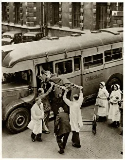Patient on stretcher lifted onto evacuation coach 1939 Patient on stretcher lifted onto evacuation coach 1939