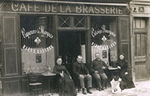 Four people and a dog outside a cafe, France Four people and a dog outside a cafe, France