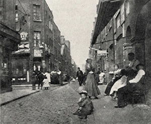 People sitting on street, Whitechapel, East London People sitting on street, Whitechapel, East London