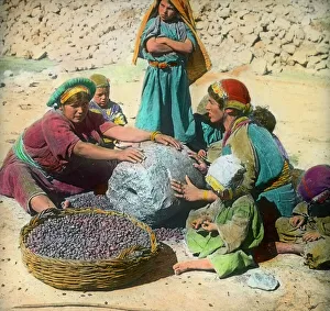 Persian women using a large grindstone, Iran Persian women using a large grindstone, Iran
