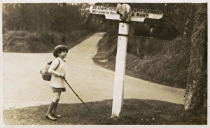 Petworth - Young boy checking his directions on a signpost Petworth - Young boy checking his directions on a signpost