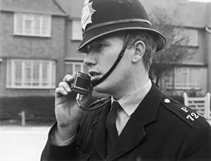 Chin Strap Gallery: Police officer using a radio, London