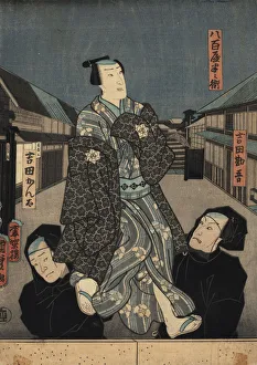 Puppet in kimono being manipulated by two bunraku puppeteers Puppet in kimono being manipulated by two bunraku puppeteers