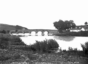 Prints of Quoile Bridge, Downpatrick - a river level view of the old stone bridge and thatched buildings to the right. (Location: Northern Ireland; County Down; Downpatrick). Date: circa early 1900s Down Prints: Early 20th Century Print of Quoile Bridge, Downpatrick