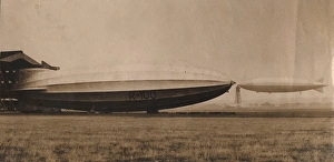 <b class=qtipBold><figcaption>R101 at the mooring mast</figcaption></b><br>The R101 at the mooring mast where she is being prepared for her flight to India; she has been lengthened by 50ft and fitted with two new engines and this is the first time out of her shed since the lengthening. Also the R100 is seen in the picture just back from the Canadian tour. This is the first time the two ships have been photographed together. Date:<br><em>© The Royal Aeronautical Society (National Aerospace Library) / Mary Evans Picture Library</em> R101 at the mooring mast