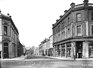 Prints of Railway Street, Lisburn - a street scene with shop fronts and few people. (Location: Northern Ireland: County Antrim: Lisburn). Date: circa early 1900s Railway Prints: Early 1900s Railway Street Print, Lisburn, Northern Ireland