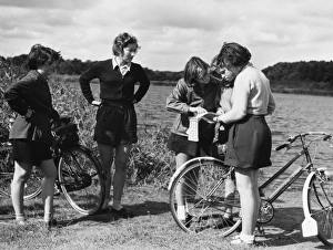 <b class=qtipBold><figcaption>Reading Cycling Map</figcaption></b><br>'Which way?' A group of schoolgirl cyclists and their teacher pause to look at a map, Hatchmere, Cheshire, England.<br><em>© Mary Evans Picture Library</em> Reading Cycling Map