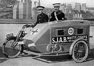 A Red Cross Ambulance with motor-cycle attached A Red Cross Ambulance with motor-cycle attached