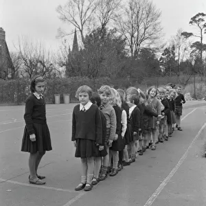 Schoolchildren line up in playground Schoolchildren line up in playground