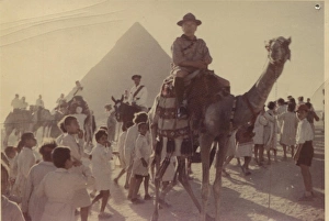 Scout leader on camel in front of pyramid, Egypt Scout leader on camel in front of pyramid, Egypt