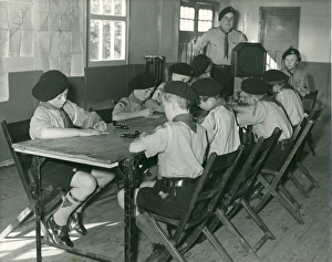 <b class=qtipBold><figcaption>Scouts learning morse code</figcaption></b><br>Nine Boy Scouts of the 1st Coulsdon Group sit around a table learning morse code, under the watchful eye of their Scout Leader. 1950<br><em>© The Scout Association / Mary Evans</em> Scouts learning morse code