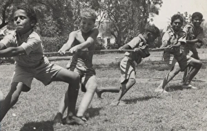 <b class=qtipBold><figcaption>Scouts playing tug of war</figcaption></b><br>Pulling Together. Native Scout visitors and boys of the 1st Khormaksar Troop in a tug of war at Sheik Othman, Aden. 1950s<br><em>© The Scout Association / Mary Evans</em> Scouts playing tug of war