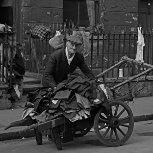 Selling second hand clothes from a barrow, London Selling second hand clothes from a barrow, London