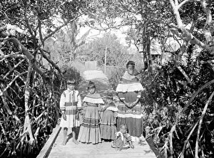 Seminole American Indian mother and children in traditonal d
