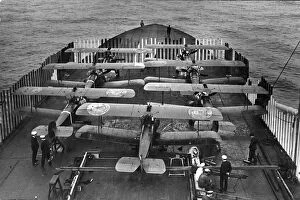 Seven Sopwith 2F1 Camels lined up on the deck of HMS Furious