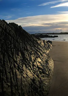 Shining black rocks at Knockbrex in Wigtown Bay, Scotland Shining black rocks at Knockbrex in Wigtown Bay, Scotland