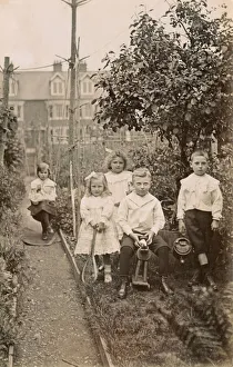 Five siblings playing in their suburban garden Five siblings playing in their suburban garden