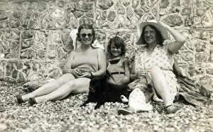 Sitting against a stone wall on a pebbly beach Sitting against a stone wall on a pebbly beach