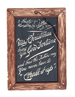 Slate with pen and comic greeting on a Christmas card Slate with pen and comic greeting on a Christmas card