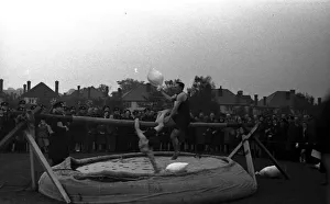 <b class=qtipBold><figcaption>Slippery pole sack fighting</figcaption></b><br>Slippery pole sack fighting at a London Fire Brigade sports event.<br><em>© London Fire Brigade / Mary Evans Picture Library</em> Slippery pole sack fighting