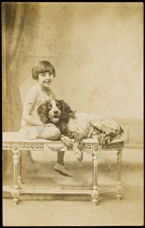 <b class=qtipBold><figcaption>Smiling Girl & Dog</figcaption></b><br>A smiling, jolly little girl, poses on a decorative table with her equally happy English Springer Spaniel pet dog.<br><em>© Mary Evans Picture Library 2015 - https://copyrighthub.org/s0/hub1/creation/maryevans/MaryEvansPictureID/10193410</em> Smiling Girl & Dog