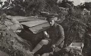 Soldier sitting by a dugout, Northern France, WW1