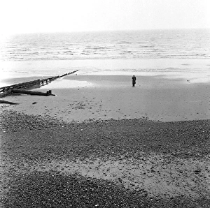 Solitary man on the beach at Eastbourne, Sussex Solitary man on the beach at Eastbourne, Sussex