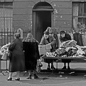 Sorting through old clothes in London's East End Sorting through old clothes in London's East End