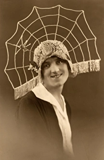 <b class=qtipBold><figcaption>Spider Web Cloche Hat</figcaption></b><br>A rather unattractive young woman models a fantastical lace cloche hat with an elaborate spiders web radiating from the back - complete with spider.<br><em>© Mary Evans Picture Library</em> Spider Web Cloche Hat