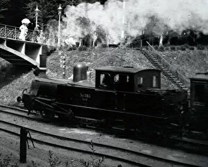 Steam train approaching a bridge