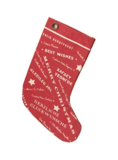 <b class=qtipBold><figcaption>Stocking</figcaption></b><br>Red fabric Christmas stocking, printed on each side with a pattern of stars and text reading 'Merry Christmas' in a variety of languages. It has a punched eyelet and an attached length of black cotton thread at the top and was manufactured in c.1960. Date: c.1960<br><em>© The Geffrye Museum of the Home / Mary Evans Picture Library</em> Stocking