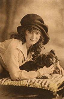 Studio portrait, young woman with Pekingese dog Studio portrait, young woman with Pekingese dog